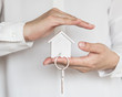 © Chinnapong - House key in home Insurance agent's hand protection