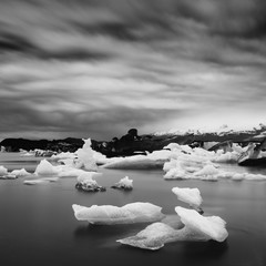 Wall Mural - Beautiful sunset over famous Diamond beach, Iceland. This sand lava beach is full of many giant ice gems, places near glacier lagoon Jokulsarlon Ice rock with black sand beach in southeast Iceland