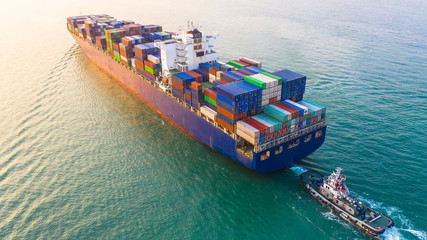 Wall Mural - Container ship arriving in port, container ship and tug boat going to sea port, logistic business import export shipping and transportation, Aerial view.