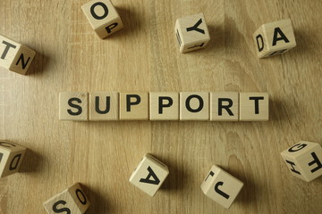 Support word from wooden blocks on desk