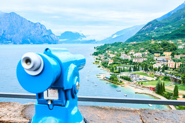 Touristic telescope in Malcesine town in Lake Garda (Lago di Garda or Lago Benaco), Italy. Selective focus