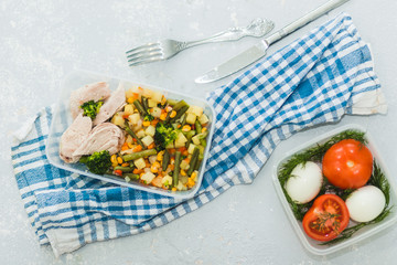 Wall Mural - Delicious and healthy lunch. Chicken meat with boiled vegetables in container on grey background, close up. Healthy food