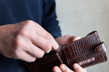 Wall Mural - Hands taking out money from wallet Concept of savings, salary, payment and funds