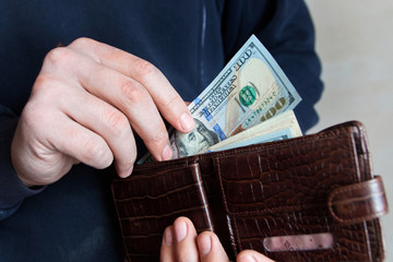 Wall Mural - Hands taking out money from wallet Concept of savings, salary, payment and funds