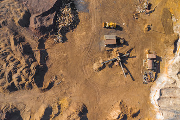 Aerial view of sandpit and factory plant producing sand materials for construction industry. Top view of industrial place. Photo captured with drone.