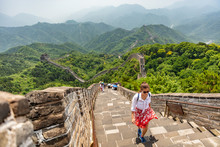 China Travel At Great Wall. Tourist In Asia Walking On Famous Chinese Tourist Destination And Attraction In Badaling North Of Beijing. Woman Traveler Hiking Great Wall Enjoying Her Summer Vacation.