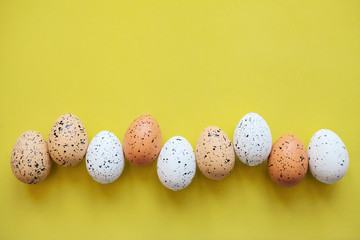 Wall Mural - Set of colored eggs on a yellow background. Festive Easter concept. Above there is a place for text.