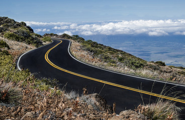 Maui Mountain Road:  The road from the top of Mt. Haleakalā begins above the clouds and descends through arid terrain to a tropical valley below.