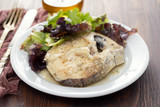 Fototapeta Sypialnia - boiled fish with sauce and green salad on white plate