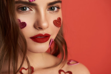 Wall Mural - Pretty naked brunette girl is decorated with heart-shaped stickers indoors