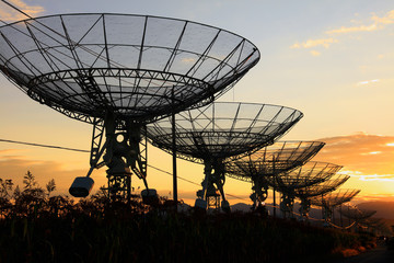 The silhouette of a radio telescope