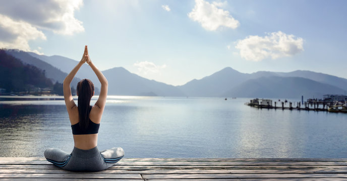 young woman practicing yoga in the nature