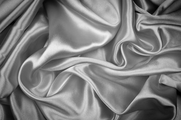 Black silk texture luxurious satin for abstract background. Dark tone