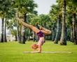 © romaset - Beautiful young woman practic yoga at the beach. Early morning exercise