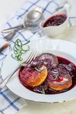 Fototapeta  - Curd pancakes with cherry sauce with rosemary.
