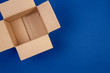 © vejaa - Open empty cardboard boxes on blue background