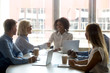 © fizkes - Black team leader shaking hands with aged businesswoman during meeting