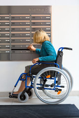 Wall Mural - woman on wheelchair checking mailbox