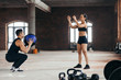 © alfa27 - sporty man and woman throwing a fitness ball to each other in the sport center. full length photo. cross fit
