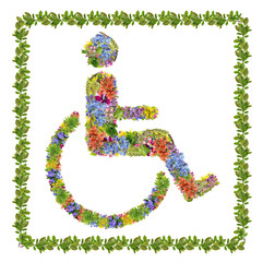 Wall Mural - person in a wheelchair symbol made from spring flowers and plants isolated