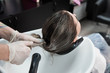 © strigana - Beauty concept - Professional hairdresser applying shampoo, washes color paint off and massaging hair of a customer. Woman having her hair washed in a hairdressing beauty salon