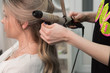 © strigana - Professional hairdresser makes curls using curling