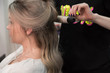 © strigana - Professional hairdresser makes curls using curling