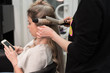 © strigana - Professional hairdresser makes curls using curling