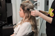 © strigana - Professional hairdresser makes curls using curling
