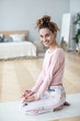 © BestForYou - Portrait of a beautiful smiling woman practicing yoga at home.