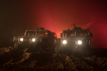 War Concept. Military silhouettes fighting scene on war fog sky background, Fighting silhouettes Below Cloudy Skyline At night. Battle scene. Army vehicle with soldiers. army