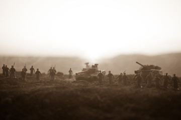 War Concept. Military silhouettes fighting scene on war fog sky background, World War Soldiers Silhouettes Below Cloudy Skyline at sunset. Attack scene. Armored vehicles.