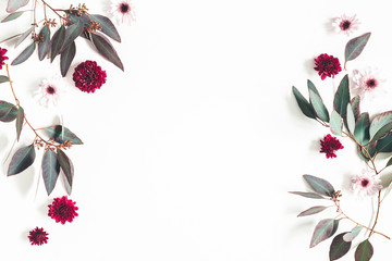 Flowers composition. Eucalyptus leaves and pink flowers on white background. Flat lay, top view, copy space