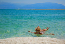Girl Relaxing In The Water Of Dead Sea