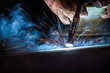 © sakarin14 - Industrial welder welding fabricated construction in factory, Welding process by Flux Core Welding, FCAW