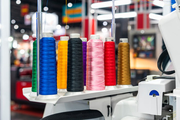 many colorful cotton reel thread set up at modern and automatic high technology sewing or embroidery