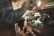 © bodnarphoto - Close -up photo, barista steaming milk in pitcher on a professional coffee machine. Barista professional cooks coffee in the coffee shop. Man makes a cappuccino on a professional coffee machine.