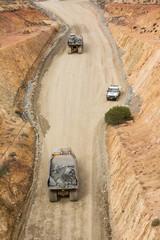 Wall Mural - Trucks laden with ore leaving a copper mine tunnel in NSW Australia.