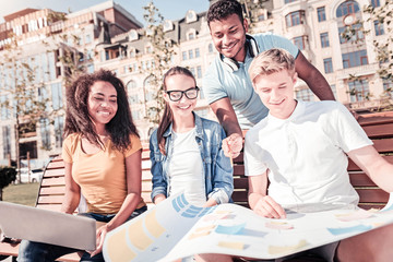 Wall Mural - Cheerful male person standing behind his friends