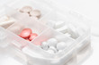 © o_lypa - Close-up of drug box with various pills, capsules