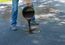 Pouring Tar, Asphalt Onto Driveway For Resealing