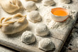 © Алексей Еремеев - Uzbek national food Chuchvara, like dumplings, on a wooden board, lie in flour with an egg