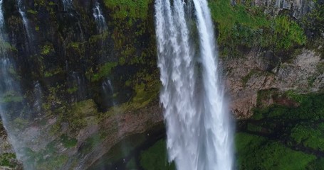 Wall Mural - Aerial drone footage of waterfall Seljalandsfoss on Iceland in Icelandic nature. Famous tourist attractions and landmarks destinations in Icelandic nature landscape on the ring road, South Iceland.