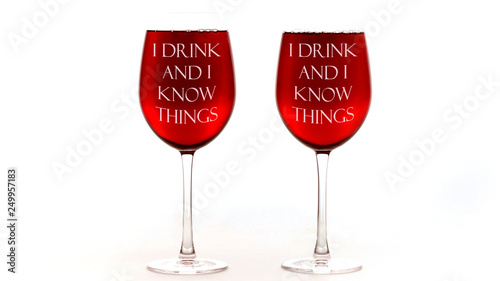 Fotografía Red wine glasses with I drink and I know things text on white background