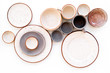 Kitchen concept. Crockery kit. Empty ceramic plates and mugs on white background top view
