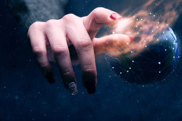 Poster - Woman touching planet with finger and network web and burn nebula dust. Mixed media.