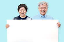 Happy Grandpa And Grandma Smiling With White Teeth, Enjoy Moment And Holding A Blank Board. Asian Grandparents Showing White Blank Board For Your Advertising Text Message Or Promotional Content.