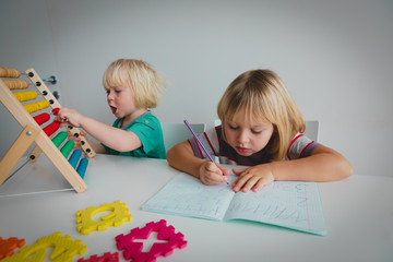 Wall Mural - little girls learn to write and culculate numbers
