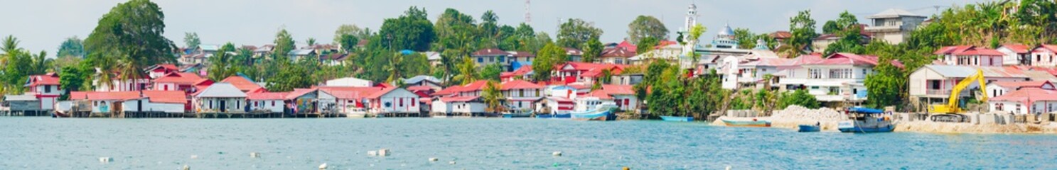 Wall Mural - Red and white village at Tual, Kei Kecil island, Moluccas. A colorful slum called Kampung Merah Putih, colors of Indonesia national flag. High resolution panorama.