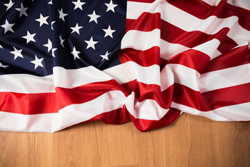 Flag of United States on a wooden table background.